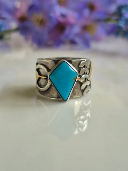 Silver ring with a tuquoise stone on a white background