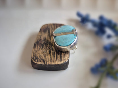 Jewelry with turquoise stone and wooden finish on a light background