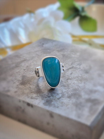 Gem silica ring on a stone surface with a blurred background